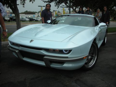 1998 Ford Crown Victoria - A custom car with a retro-inspired design is displayed outdoors.