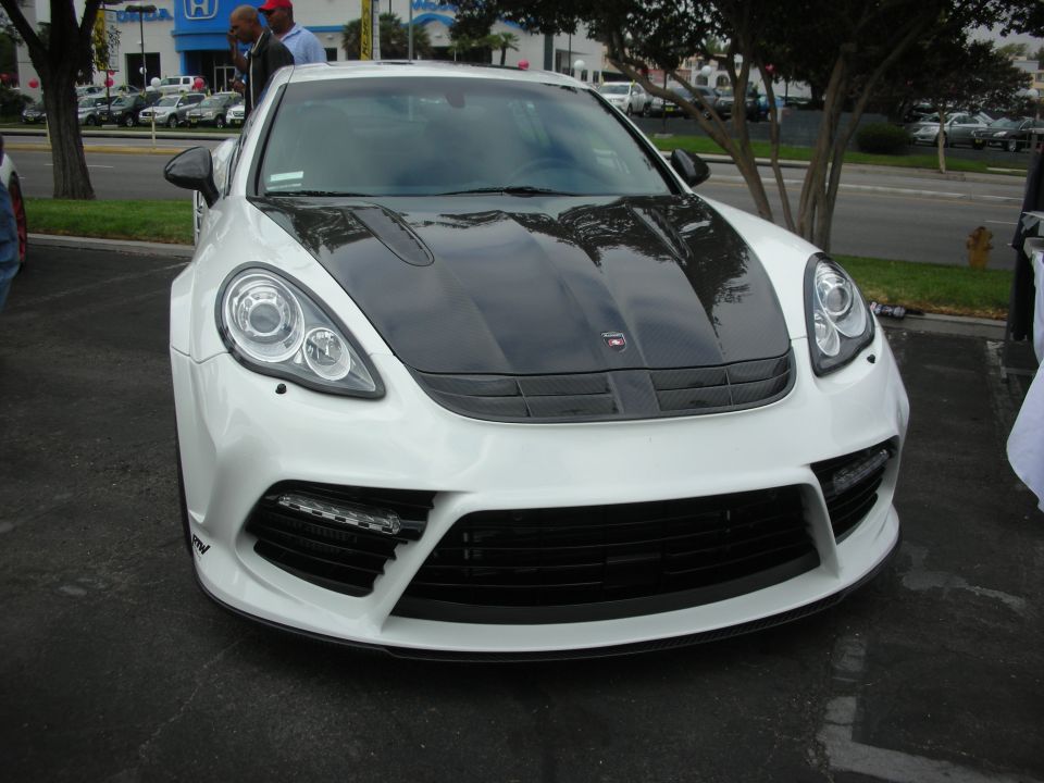 White Porsche Panamera with carbon fiber hood and wide body kit, front view