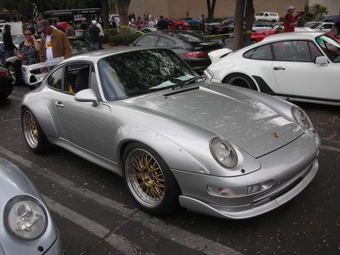 1998 Ford Crown Victoria - Silver Porsche 911 with wide body kit and gold BBS wheels at a car meet.