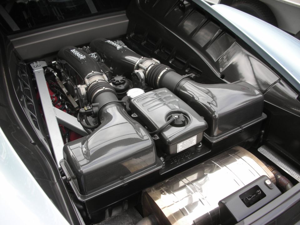 Engine bay with V8 engine components, intake runners, and exhaust system