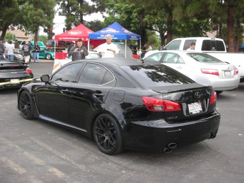1998 Ford Crown Victoria - Rear view of a modified black Lexus IS sedan at a car meet, showing custom wheels and exhaust.