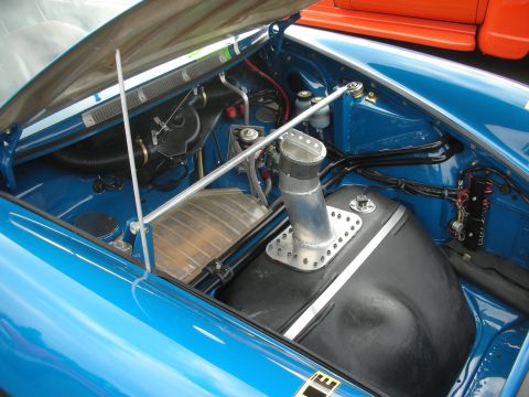 1998 Ford Crown Victoria - Custom fuel tank and filler neck in a blue car's engine bay.