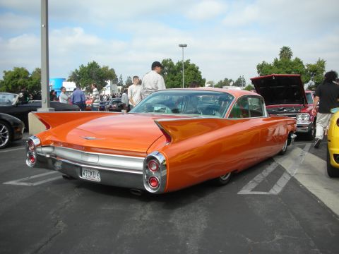 1998 Ford Crown Victoria - Rear view of a custom orange 1959 Cadillac Coupe de Ville at a car show.