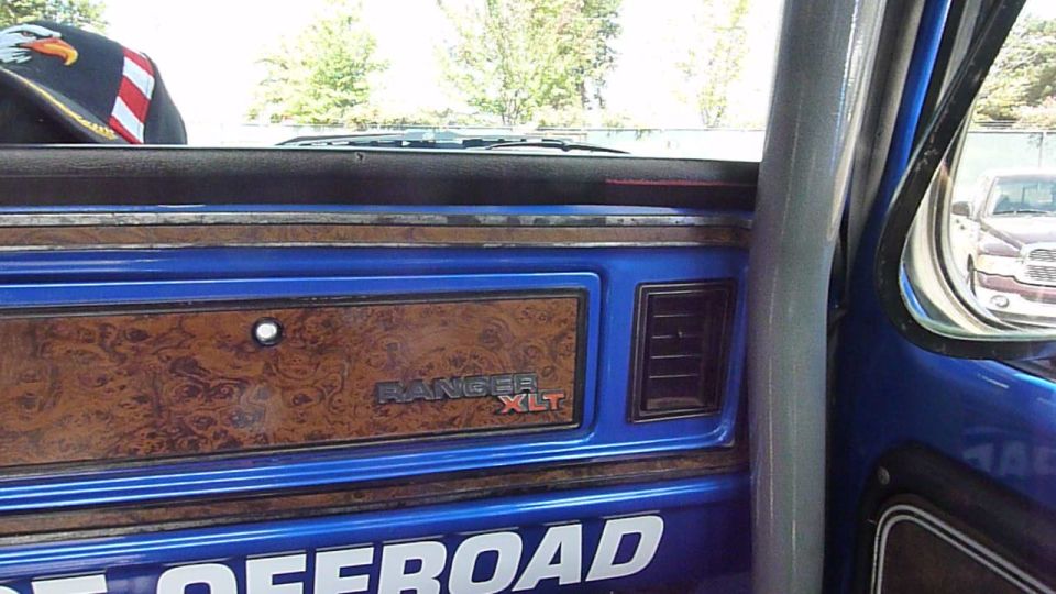 Blue interior dashboard with wood grain trim and "RANGER XLT" badge