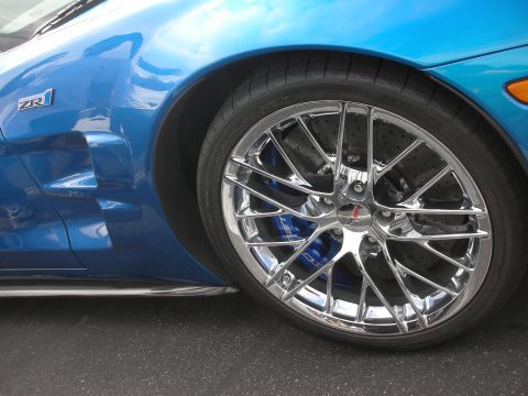 1998 Ford Crown Victoria - Close-up of a blue sports car's side, showing the ZR1 badge and a chrome wheel.