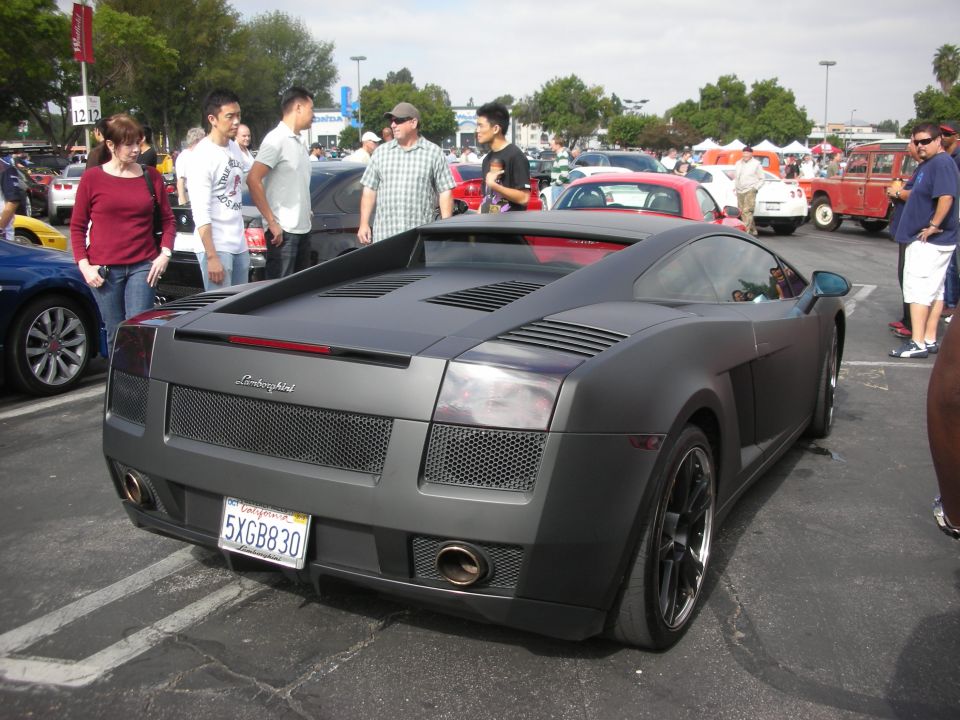 Matte gray Lamborghini Gallardo parked at an outdoor car meet