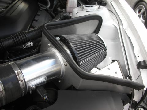 1998 Ford Crown Victoria - Close-up view of an aftermarket engine air intake system, a black cone filter and polished aluminum piping.