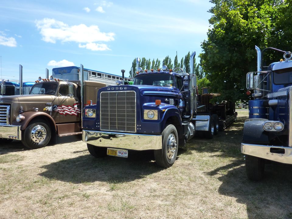Blue Dodge truck front view with chrome grille and bumper
