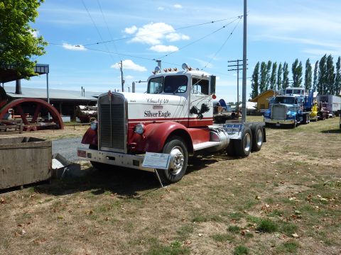 1981 Kenworth W900A - A classic Kenworth truck, labeled 'Silver Eagle', is displayed outdoors with other vehicles in the background.