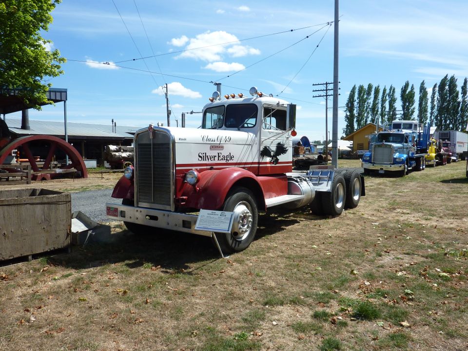 Restored red and white vintage Kenworth tractor lettered Silver Eagle at an outdoor truck show