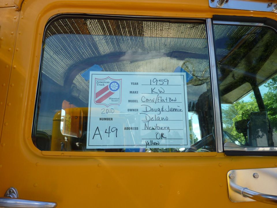 Card on truck window lists year 1959, make KW, model Conv/Flat Bed, owner Doug & Jennie Delano, address Newberg OR, number A49