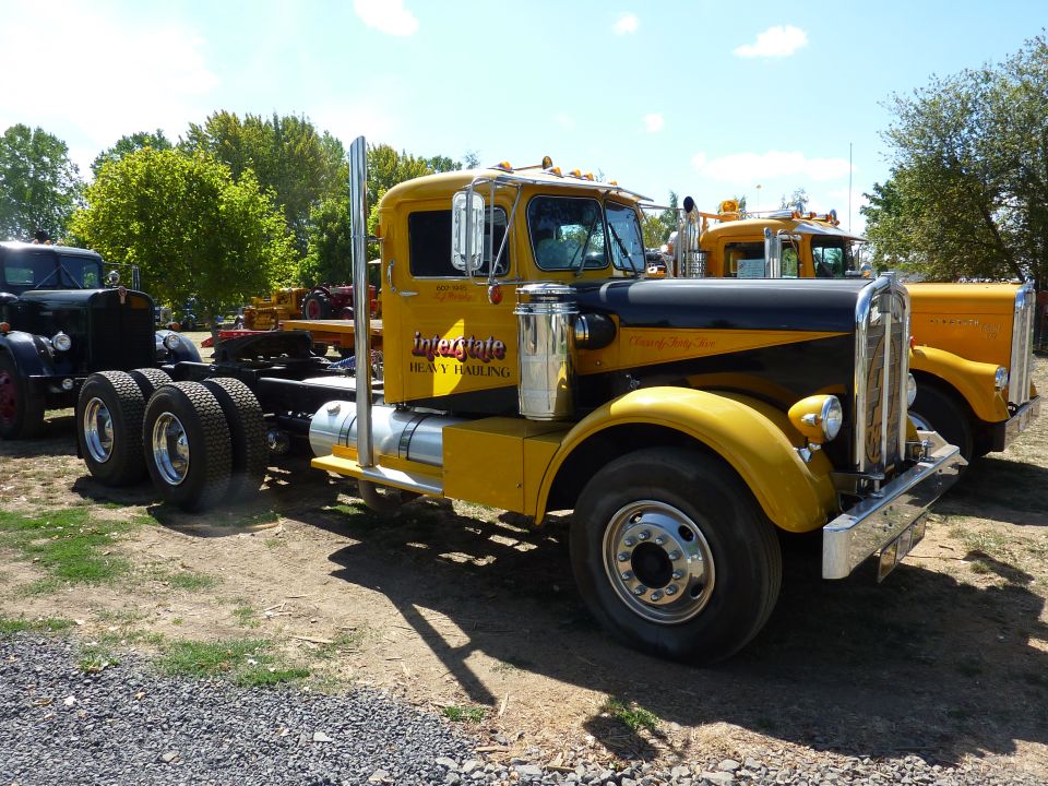Yellow and black semi-truck with 'Interstate Heavy Hauling' on door