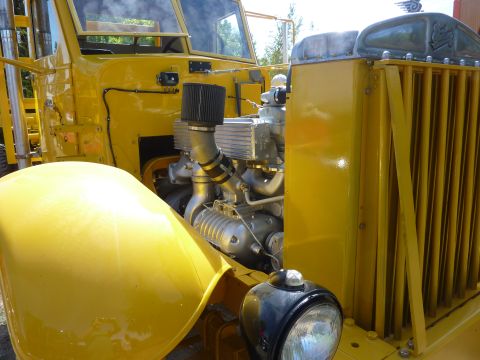 1981 Kenworth W900A - Close-up view of a yellow truck's engine compartment and front grille.
