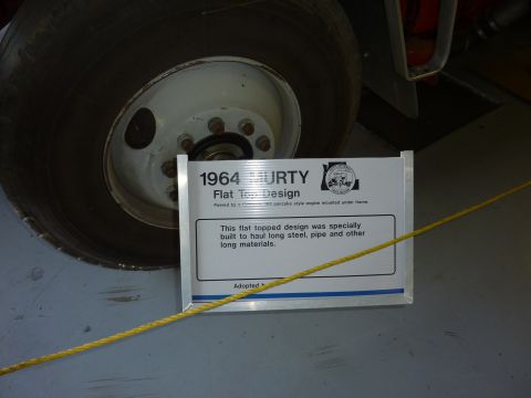 1981 Kenworth W900A - A sign details the 1964 MURTY Flat Top Design, with a large tire visible behind it.