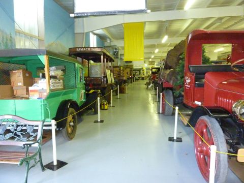 1981 Kenworth W900A - A green vintage delivery truck is parked in a museum alongside other historic vehicles.