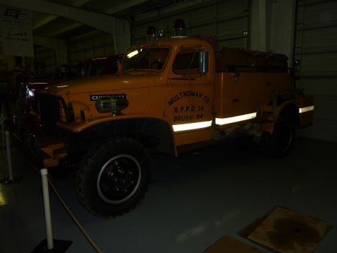 1981 Kenworth W900A - This vintage fire truck, marked for Multnomah County RFPD 14 Brush 64, is displayed indoors.