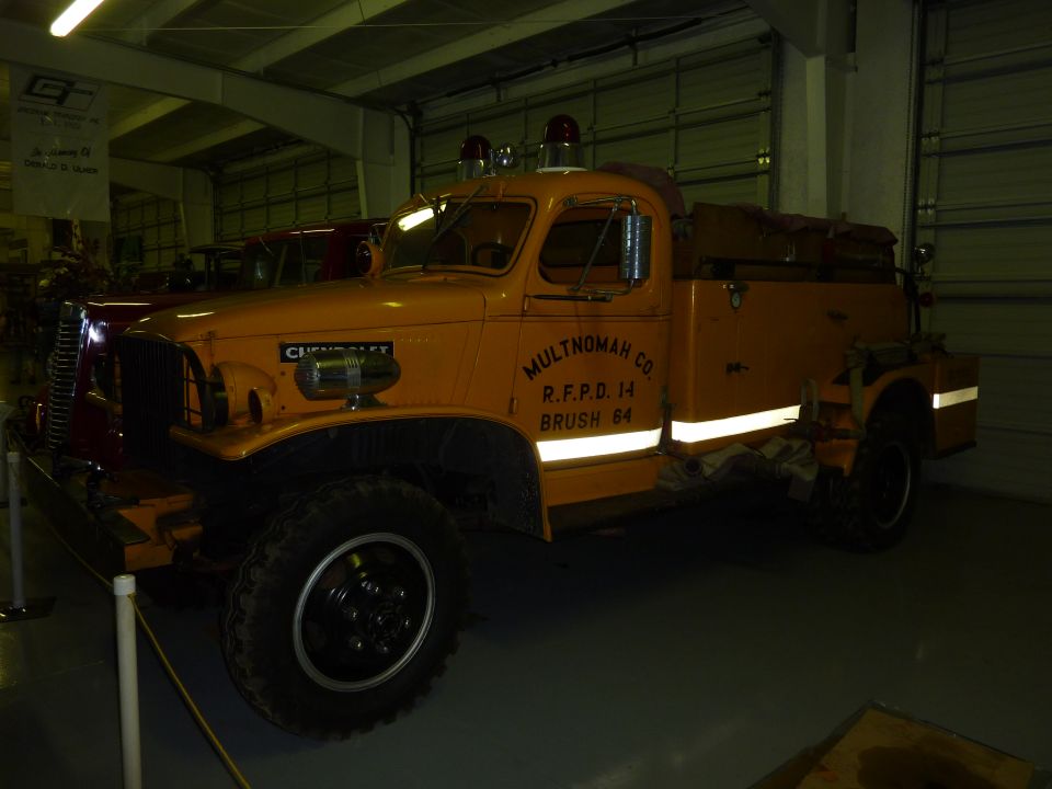 Orange fire truck with "MULTNOMAH CO R.F.P.D. 14 BRUSH 84" on the side