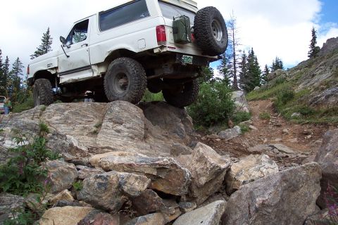1987 Ford Bronco - Keith climbing a sizable obstical like it is a curb