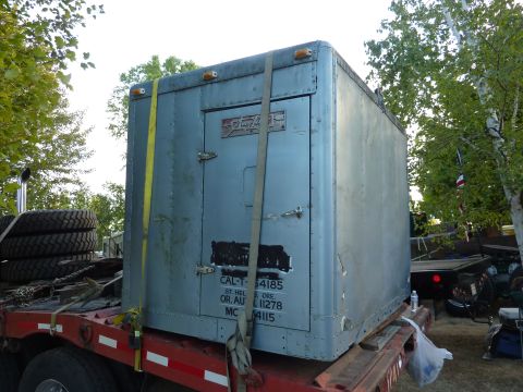 1981 Kenworth W900A - A truck sleeper cab is secured to a flatbed trailer, ready for transport.