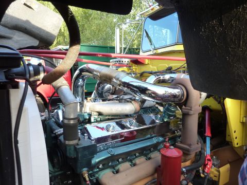 1981 Kenworth W900A - Close-up view of a large truck engine with polished chrome components and a green engine block.