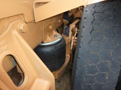 1981 Kenworth W900A - Close-up view of a truck's air suspension bag and tire, showing mechanical components.