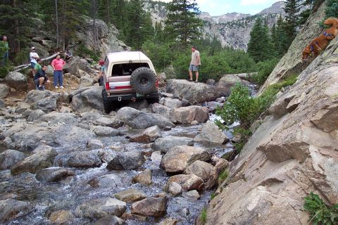 1987 Ford Bronco - Steve climbing out of French's Creek with some difficulty. notice me in the beige shirt woundering how my bronco is going to go up it.