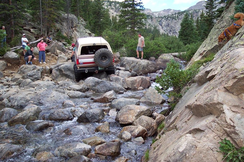 Steve climbing out of French's Creek with some difficulty.  notice me in the beige shirt woundering how my bronco is going to go up it.
