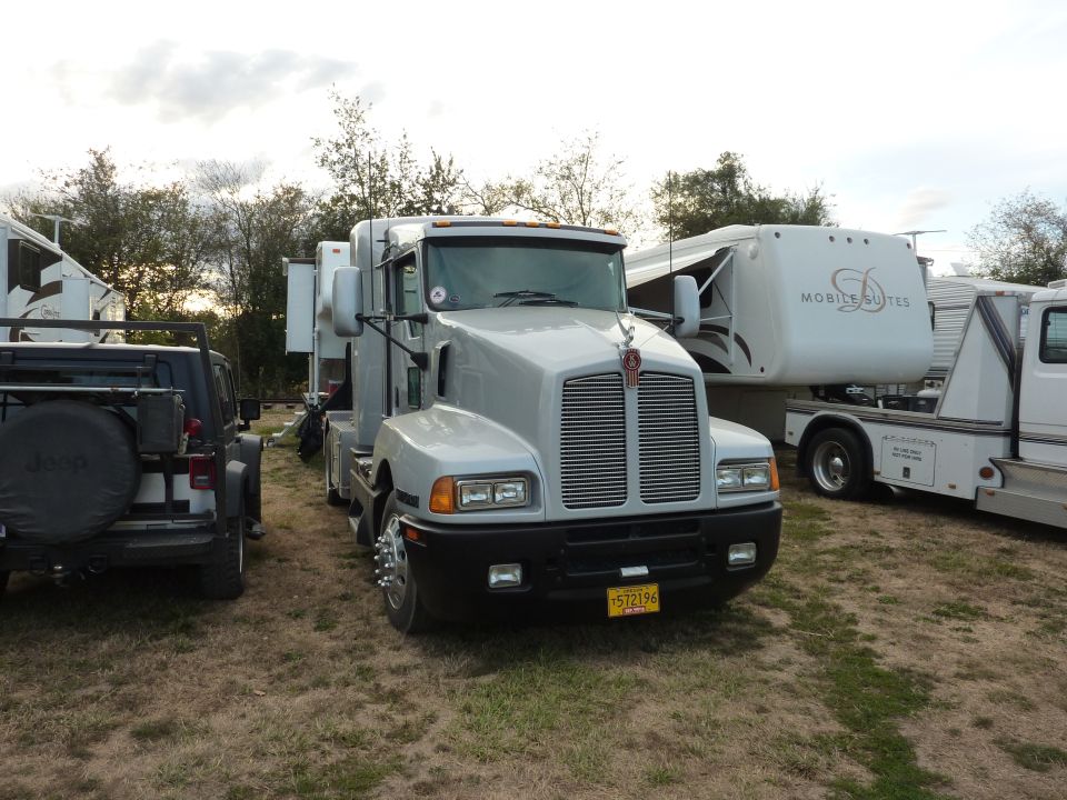 Silver semi-truck with a prominent grille and a hood ornament