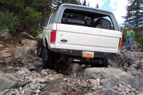 1987 Ford Bronco - me very stuck, gas tank skid plate is on the rock...