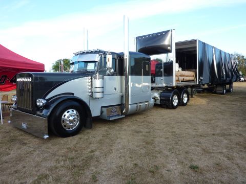 1981 Kenworth W900A - This Peterbilt 379 semi-truck is paired with a black curtain-side trailer.