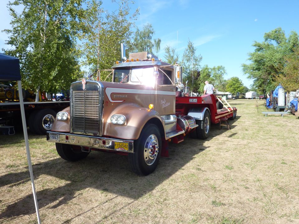 Kenworth truck, looks like a 1962 model, pulling a red trailer