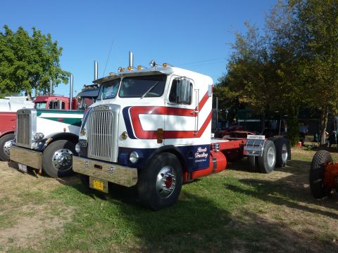 1981 Kenworth W900A - A classic semi-truck cab, likely from the 1970s, is parked outdoors with other vehicles visible.