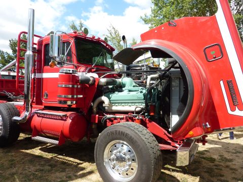 1981 Kenworth W900A - This red 1981 Kenworth W900A has its hood open, displaying the engine and other components.