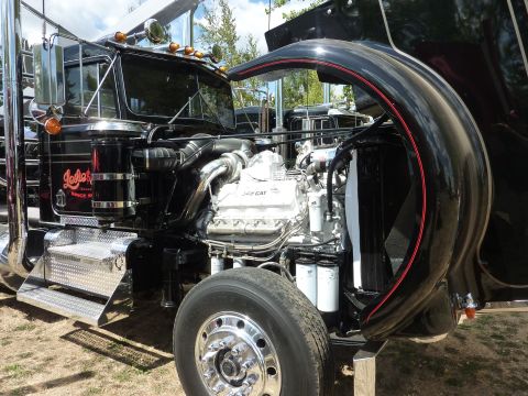 1981 Kenworth W900A - Close-up of a truck's engine compartment, the CAT engine and chrome accents.