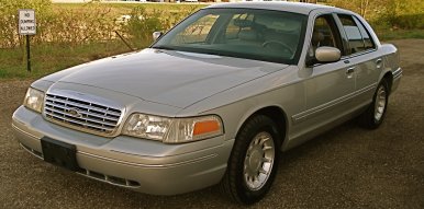 2000 Ford Crown Victoria - This 2000 Ford Crown Victoria is shown from the front quarter angle, highlighting its grille and overall sedan body style.