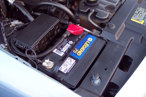 2001 Ford Crown Victoria - The engine bay shows a car battery with visible text and electrical components.