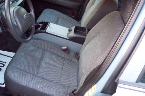 2001 Ford Crown Victoria - Front seats and steering wheel of a car's interior are visible.