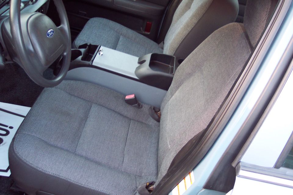 Interior view of a car showing front seats, steering wheel, and center console