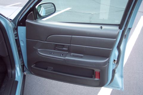 2001 Ford Crown Victoria - Close-up view of the interior door panel of a vehicle.