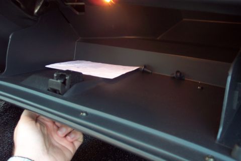 2001 Ford Crown Victoria - Interior view of a car's glove compartment, showing contents and structure.