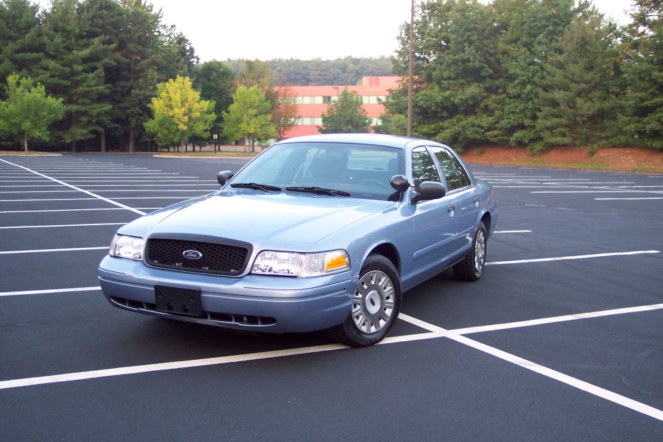 Blue 2001 Ford Crown Victoria parked in an empty lot