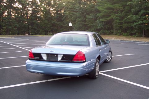 2001 Ford Crown Victoria - This 2001 Ford Crown Victoria sedan is seen from the rear in a parking lot.