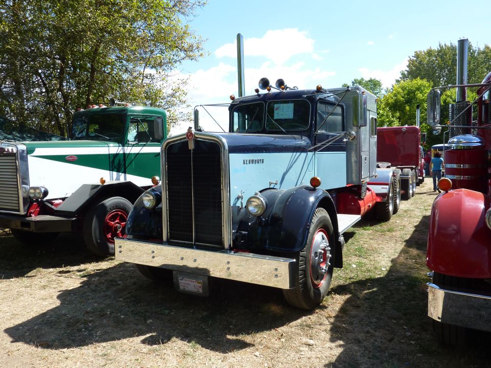 Two-tone blue vintage Kenworth conventional truck, front quarter, at a truck show