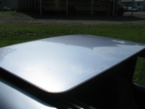 1994 Ford Probe - A silver sunroof is visible with a school bus in the background.