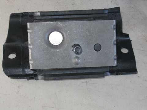 1991 Ford Bronco - A close-up view of a vehicle's motor mount, a metal plate secured to a rubber base.