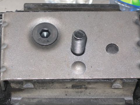 1991 Ford Bronco - Metal motor mount assembly with a hex bolt and a threaded stud visible.