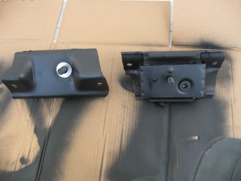 1991 Ford Bronco - Two engine mounts are shown side-by-side on a surface that appears to be cardboard.