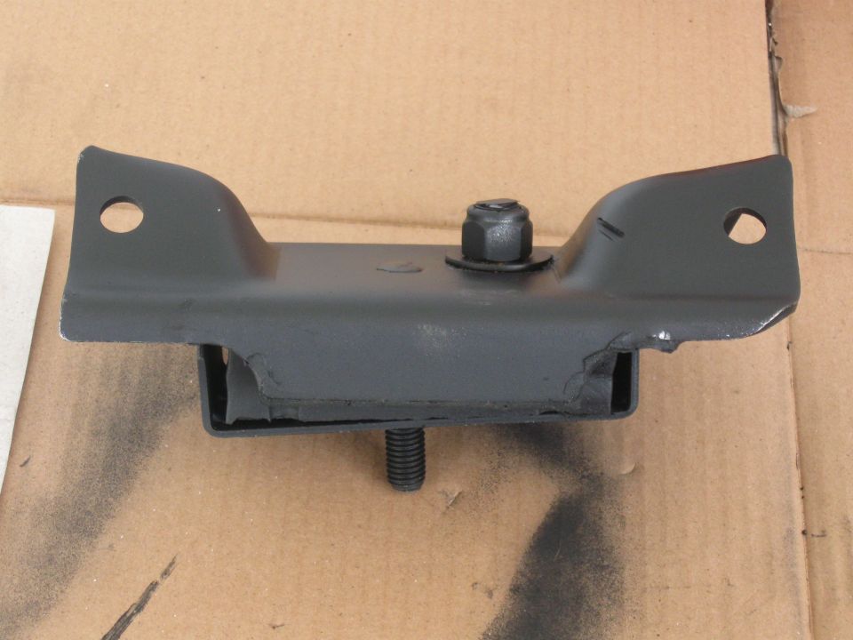 black metal engine mount with rubber isolator and bolts, on cardboard