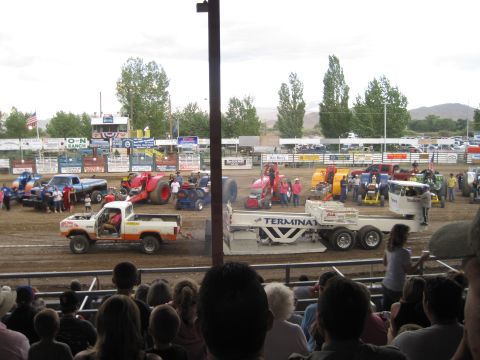 1989 Ford Bronco - Spectators watch modified tractors and trucks compete in a tractor pull event.