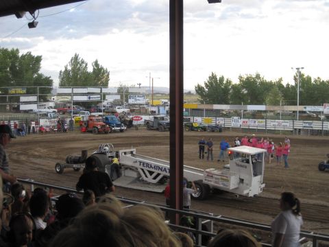 1989 Ford Bronco - Spectators watch a tractor pull event modified vehicles and a large crowd.